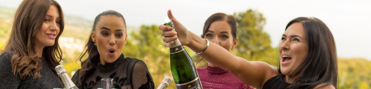 Woman Popping Bottle of Champagne